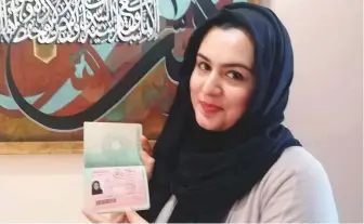  ??  ?? Pakistani expatriate woman Rubab Zahra displays her UAE Golden Visa which she says is a reward for her works in the field of arts after she left her science career.