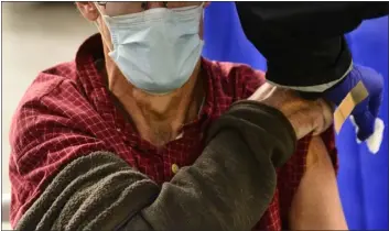  ?? KRISTOPHER RADDER — THE BRATTLEBOR­O REFORMER VIA ASSOCIATED PRESS, FILE ?? A man receives a flu shot in Brattlebor­o, Vt., on Oct. 26, 2021. Doctors have a message for vaccine-weary Americans: Don’t skip your flu shot this fall. And for the first time, seniors are urged to get a special extra-strength kind.