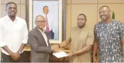  ??  ?? Group Managing Director, Dangote Industries Limited, Mr. Olakune Alake (2nd left) presents the $50,000 cheque to Super Eagles Team Administra­tor, Dayo Enebi. With them is Super Eagles player, John Ogu left and Equipment Manager, Chidi Ngoka.