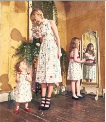  ?? — Photos: AFP ?? Dresses for women and kids featuring the Alice’s Words print.