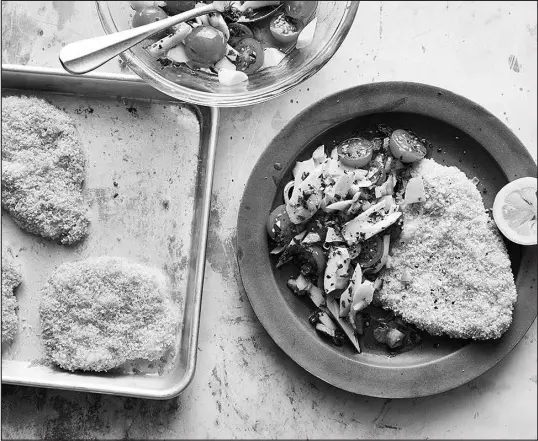  ?? DAVID MALOSH / THE NEW YORK TIMES ?? Breaded and fried cutlets cut across a broad swath of cuisines; this iteration of sheet-pan crispy pork schnitzel is baked in the oven for greater efficiency and less mess.