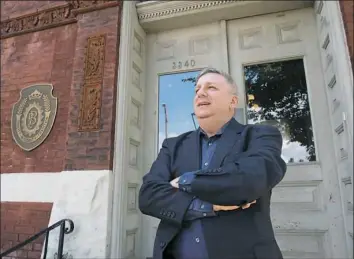  ?? Rebecca Lessner/Post-Gazette ?? Brewing attorney Cris Hoel stands outside the old Pittsburgh Brewing building in Lawrencevi­lle. Michael Carlow fired him the day Mr. Carlow took over the brewery, but now that the business is under new management, 24 years later he's been hired back.