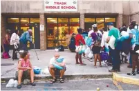  ??  ?? People line up to enter a hurricane shelter at Trask Middle School in North Carolina yesterday.