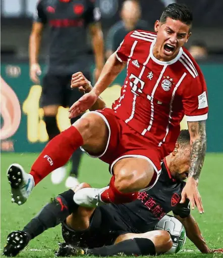  ??  ?? Watch it: Bayern Munich’s James Rodriguez is fouled in the Internatio­nal Champions Cup match against Arsenal in Shanghai on July 19. — Reuters