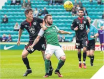  ??  ?? Hibernian’s James Keatings battles for the ball against St Mirren’s Jack Baird.