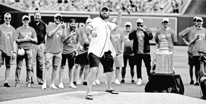  ?? BRAD MILLS/USA TODAY SPORTS ?? The Stanley Cup trophy also was present June 8 when Capitals left wing Alex Ovechkin threw out the ceremonial first pitch before a Nationals game.