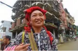  ??  ?? A Dao ethnic woman selling tourist souvenirs in front of a new hotel under constructi­on in the northern Sapa tourist town.