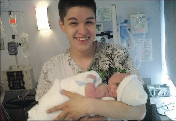  ??  ?? Justin Brooks holds his newborn son Lucas in a July, 2012 family photo. Brooks was found dead in the water in Prince Rupert in March.