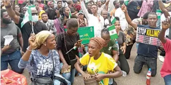  ??  ?? Protesters on their kneels at the Computer Village, Lagos, in honour of victims killed by the police. PHOTO: ENIOLA DANIEL