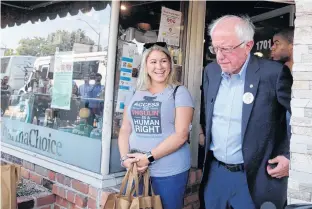  ?? REUTERS ?? U.S. citizen Jillian Rippolone, who lives with Type 1 diabetes, walks out of a Canadian pharmacy with U.S. Sen. Bernie Sanders after purchasing lower priced insulin in Windsor, Ont., on Sunday.