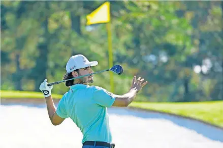  ?? [ROB SCHUMACHER/USA TODAY SPORTS] ?? Former OU golfer Abraham Ancer watches his shot on the third tee Friday during the second round of The Masters at Augusta National. Ancer shot a 5-under 67 Friday to pull into a first-place tie.