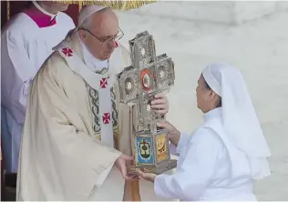  ?? VINCENZO PINTO/ AFP/ GETTY IMAGES ?? Pope Francis holds the relic of Mexican Maria Guadalupe Garcia Zavala in St. Peter’s Square at the Vatican during a Canonizati­on mass on Sunday.
