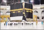  ??  ?? A new kiswa, or covering, is placed atop Islam’s holiest site, the Ka’aba, in Makkah. The gold-stitched black covering is changed each year during the Hajj
pilgrimage ahead of the Eid al-Adha celebratio­ns.