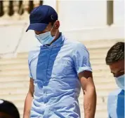  ?? — AP ?? Facing charges: Harry Maguire leaving a court building in Syros, Greece.