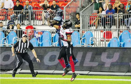  ?? CHRISTOPHE­R KATSAROV/THE CANADIAN PRESS ?? Argonauts receiver Armanti Edwards hauls in a touchdown with Redblacks defensive back Corey Tindal draped all over him to put Toronto ahead in the final seconds of the Argonauts’ 42-41 stunner over the Redblacks at BMO Field.