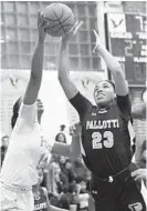  ??  ?? Pallotti’s Vashae Rideout, right, tries to shoot against Poly’s Ajae Petty in the first half Saturday.