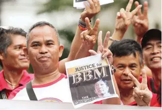  ?? (Jansen Romero) ?? STILL HANGING — Supporters of former senator Ferdinand ‘Bongbong’ Marcos Jr. gather in front of the Supreme Court on Tuesday awaiting the ruling on his election protest against Vice President Leni Robredo. The High Court deferred to October 15 the release of its resolution on the results of the manual recount and revision in ballots.