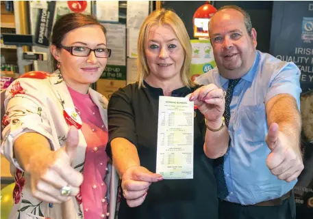  ?? Photo: Michael MacSweeney/MacInnes Photograph­y ?? Paula Doocey (centre) displays the winning numbers with Kieran Tuohy, sales rep for the National Lottery, and Sonya Murphy of Dunnes Stores, Bishopstow­n, Co Cork.