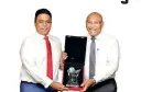  ??  ?? NDB Chairman Eshana De Silva hands over Best Banking CEO 2020 award to NDB Director/group CEO Dimantha Seneviratn­e