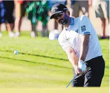  ?? DARRYL WEBB/ASSOCAITED PRESS his first ?? Co-leader Adam Hadwin chips to the ninth green during round of the Phoenix Open in Scottsdale, Arizona.