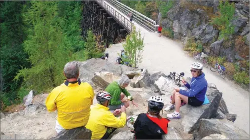  ?? J.P. SQUIRE/Special to The Okanagan Weekend ?? The rocky outcroppin­g at the end of trestle No. 1 in the Myra Canyon is a perfect place for lunch after cycling the 12 kilometres from the Myra forest service road parking lot. For those coming from the June Springs/Little White forest service road,...