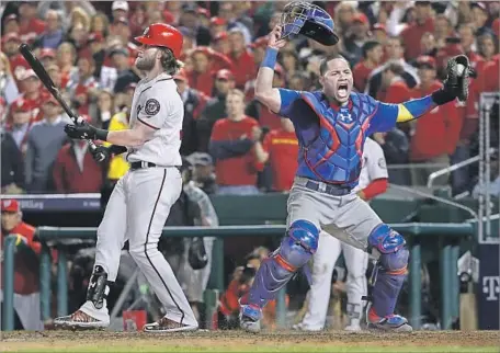  ?? Pablo Martinez Monsivais Associated Press ?? CUBS CATCHER Willson Contreras rejoices after Nationals right fielder Bryce Harper strikes out for the final out of Game 5.