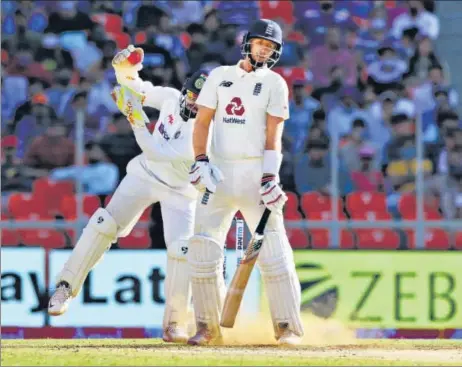  ?? BCCI ?? India keeper Rishabh Pant gathers an Axar Patel delivery that surprised Joe Root by kicking up from length on Day 2 of the third Test in Ahmedabad.