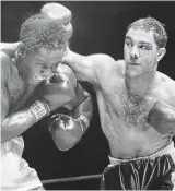  ?? ?? Ouch! Rocky Marciano delivering the Suzie Q to Ezzard Charles in 1954
