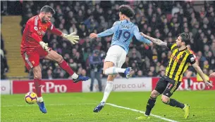  ?? EPA ?? Manchester City’s Leroy Sane, centre, scores with his chest against Watford at Vicarage Road.