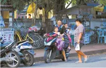  ?? Courtesy of Korea Airports Corp. ?? Local residents are seen along Sisavangvo­ng Street in Luang Prabang, Laos, Nov. 17.