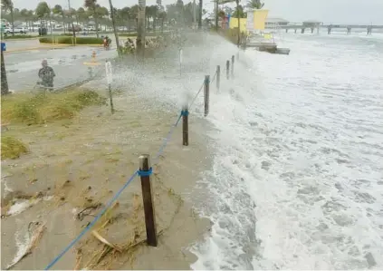  ?? JOE CAVARETTA/SOUTH FLORIDA SUN SENTINEL ?? Gusty winds brought strong waves across South Florida beaches, including near the Hollywood Broadwalk, on Thursday. The forecast calls for more rain and wind gusts through the weekend.