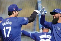  ?? ?? Los Angeles Dodgers designated hitter Shohei Ohtani (17) and Teoscar Hernández, right, participat­e in spring training baseball workouts Friday at Camelback Ranch in Phoenix. (AP photo/ashley Landis)