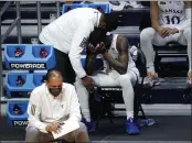  ?? PAUL SANCYA — THE ASSOCIATED PRESS ?? Kansas guard Marcus Garrett is comforted by staff during the second half of Monday’s second-round game against USC at Hinkle Fieldhouse in Indianapol­is.