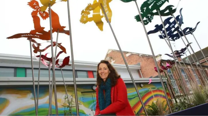  ??  ?? Artist Breda Marron with her art installati­on at the extended and renovated Dundalk CBS Primary School.