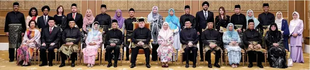  ??  ?? Sultan Muhammad V (seated centre) with the new federal cabinet. The King is flanked by Dr Mahathir and Dr Wan Azizah. — Bernama photo