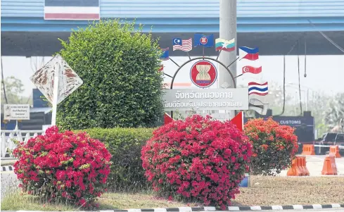  ?? AFP ?? This photo taken in March shows a sign showcasing the flags of Asean countries at the border between Thailand and Laos, in Nong Khai.