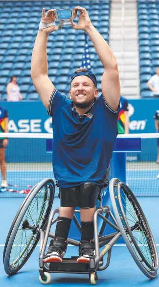  ??  ?? Dylan Alcott holds aloft his championsh­ip trophy in New York. Picture: Getty Images