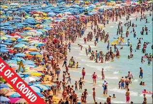  ??  ?? PACKED OUT: Sunseekers flock to the beach in the Spanish resort