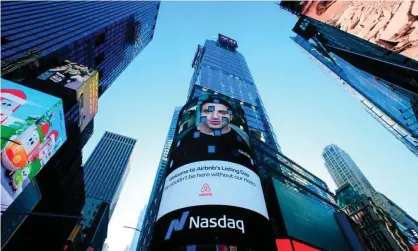  ?? Photograph: Kena Betancur/AFP/Getty Images ?? The Airbnb logo displayed on the Nasdaq digital billboard in Times Square. Airbnb now has over 7m short-term listings worldwide.