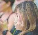  ?? Daniel Brenner, Special to The Denver Post ?? Emily Booth, who taught classes for Vaughn Bigelow Sr. at LifeTime Fitness, becomes emotional after singing the national anthem before Sunday’s 5K.