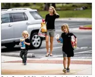  ?? RICARDO B. BRAZZIELL / AMERICAN-STATESMAN ?? Carter Dugan, 2, (left) and his brother Jackson, 5 (right), along with their mother Shannon bring items to the Circle C Community Center in South Austin last week for victims of Harvey.