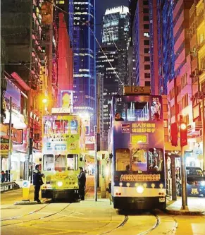  ??  ?? Explore the buzzing Hong Kong night scene on the iconic city tram.