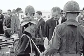  ??  ?? President Lyndon B. Johnson surveys captured weapons of the Viet Cong at Fort Campbell, Ky., in July 1966. The war came to haunt Johnson, and he announced in April 1968 that he would not seek re-election. JACK CORN/USA TODAY NETWORK