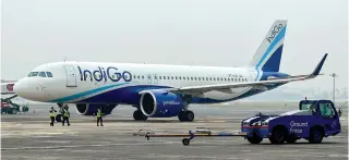  ?? AFP PHOTO ?? TAKING OFF
Ground staff walk past an Airbus IndiGo aircraft taxiing at the Netaji Subhash Chandra Bose Internatio­nal Airport in Kolkata, India, on Feb. 1, 2024. Airbus reported on Thursday, April 25, 2024, a 28-percent increase in its first-quarter profits.