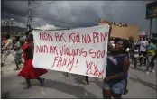  ?? JOSEPH ODELYN — THE ASSOCIATED PRESS ?? People protest in Titanyen, north of Port-au-Prince, Haiti, on Tuesday carrying a banner with a message that reads in Creole: “No to kidnapping­s, no to violence against women ! Long live Christian Aid Ministries.”