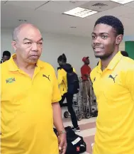  ??  ?? Dr Warren Blake (left), president of the Jamaica Athletics Administra­tive Associatio­n, and young sprint star Christophe­r Taylor.