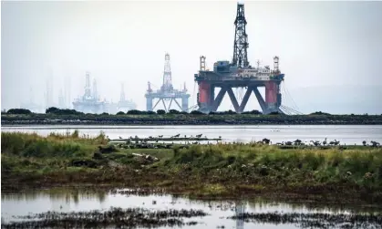  ?? Jane Barlow/PA ?? An oil rig anchored in the Cromarty Firth, Invergordo­n. Banks still investing heavily in fossil fuels despite net zero pledges. Photograph: