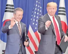  ?? — AFP photo ?? Trump (right) and South Korean President Moon Jae-in gesture after signing a trade agreement at a bilateral meeting in New York, a day before the start of the General Debate of the 73rd session of the General Assembly.