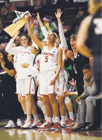  ?? Jim Gensheimer / Special to The Chronicle ?? Kaylee Johnson (5) and others on the Stanford bench cheer as the Cardinal add to their lead in the second quarter. Johnson contribute­d eight rebounds and three blocks.