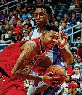  ?? KEVIN C. COX / GETTY IMAGES ?? Kent Bazemore drives against Detroit’s Stanley Johnson in a recent game. Bazemore is still playing heavy minutes as the Hawks continue to struggle.